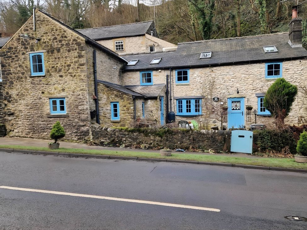 A stone cottage with blue windows and door at Rose Cottage - Cosy cottage in Millers Dale