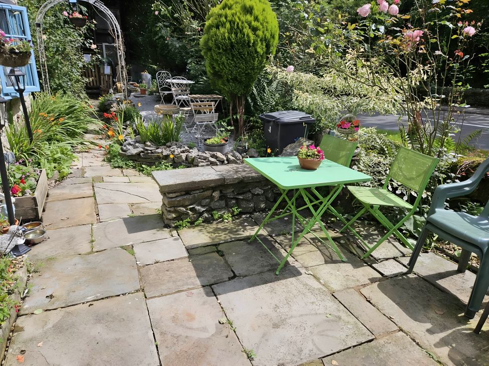 A garden with a green table and chairs at Rose Cottage - Cosy cottage in Millers Dale, Chapel-En-Le-Frith