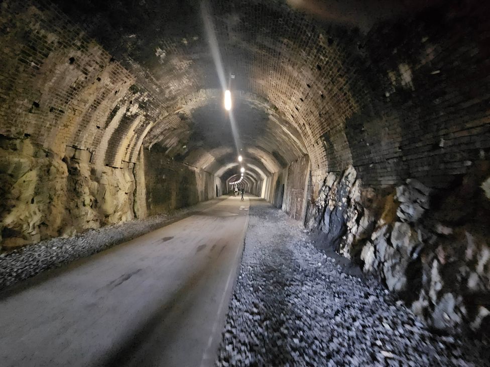 A tunnel with a pathway and light fixtures at Rose Cottage - Cosy cottage in Millers Dale, Chapel-En-Le-Frith