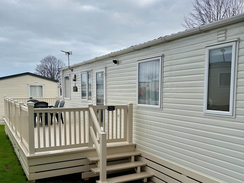 An outdoor area with a deck and chairs at Beautiful Static Caravan Hoburne Devon Bay