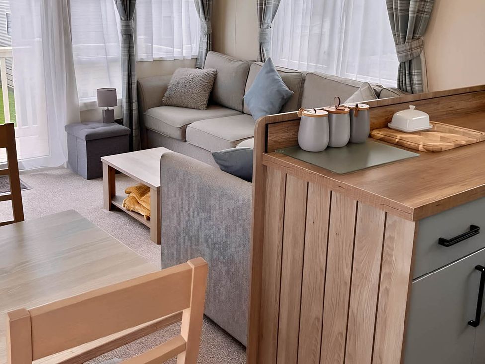 A living room with a sofa and dining table at Beautiful Static Caravan Hoburne Devon Bay
