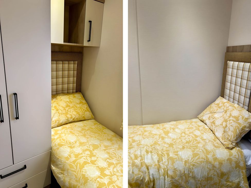 A small bedroom with a single bed and wardrobe at Beautiful Static Caravan Hoburne Devon Bay