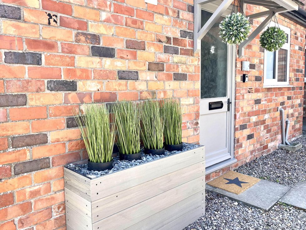 A outdoor entryway with a planter and door at Central Ellesmere - Stay 2 - Parking - PetFriendly
