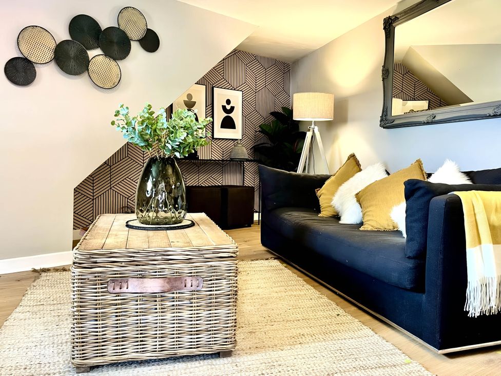 A living room with a black sofa and a coffee table at Central Ellesmere - Stay 2 - Parking - PetFriendly