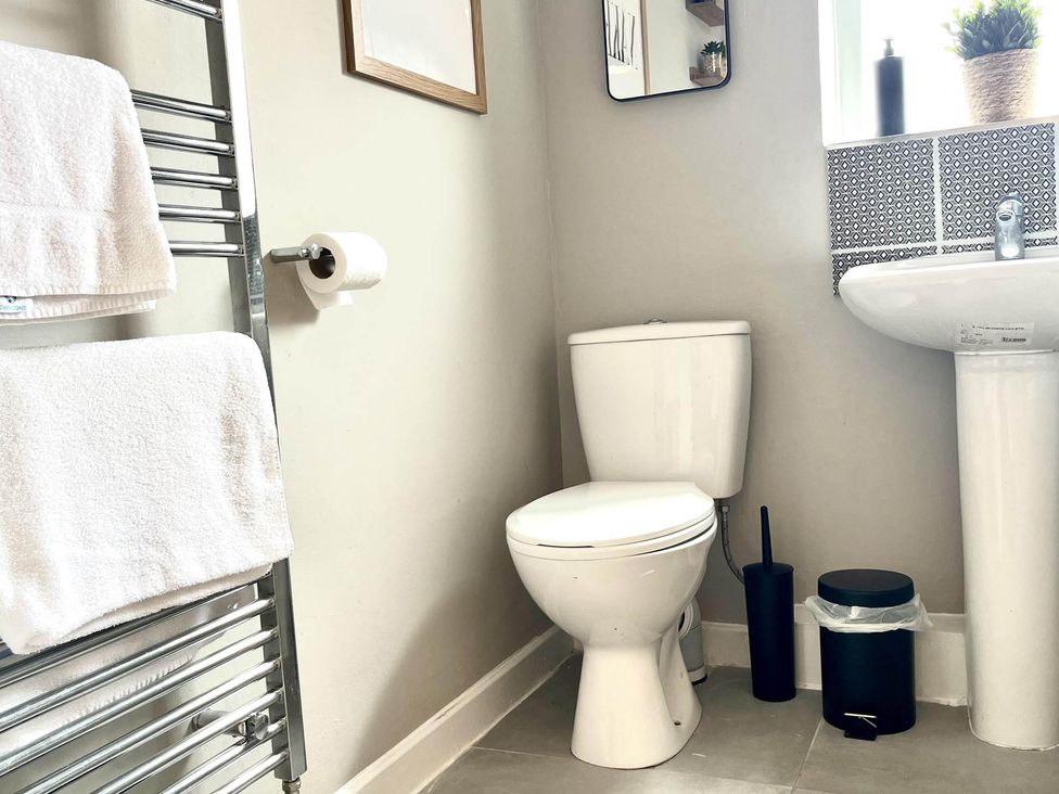 A bathroom with a toilet, sink, and towel rack at Central Ellesmere - Stay 2 - Parking - PetFriendly