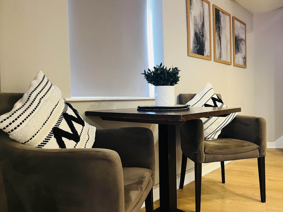 A dining area with two chairs and a table at Central Ellesmere - Stay 2 - Parking - PetFriendly