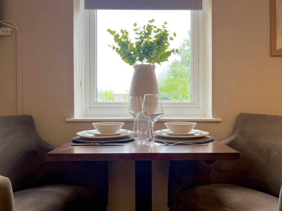 A dining table with glassware and a plant at Central Ellesmere - Stay 2 - Parking - PetFriendly