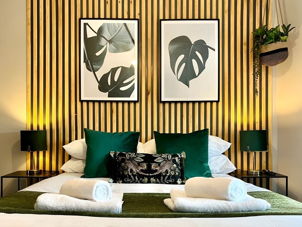 A bedroom with a bed and wall art at Central Ellesmere - Stay 2 - Parking - PetFriendly