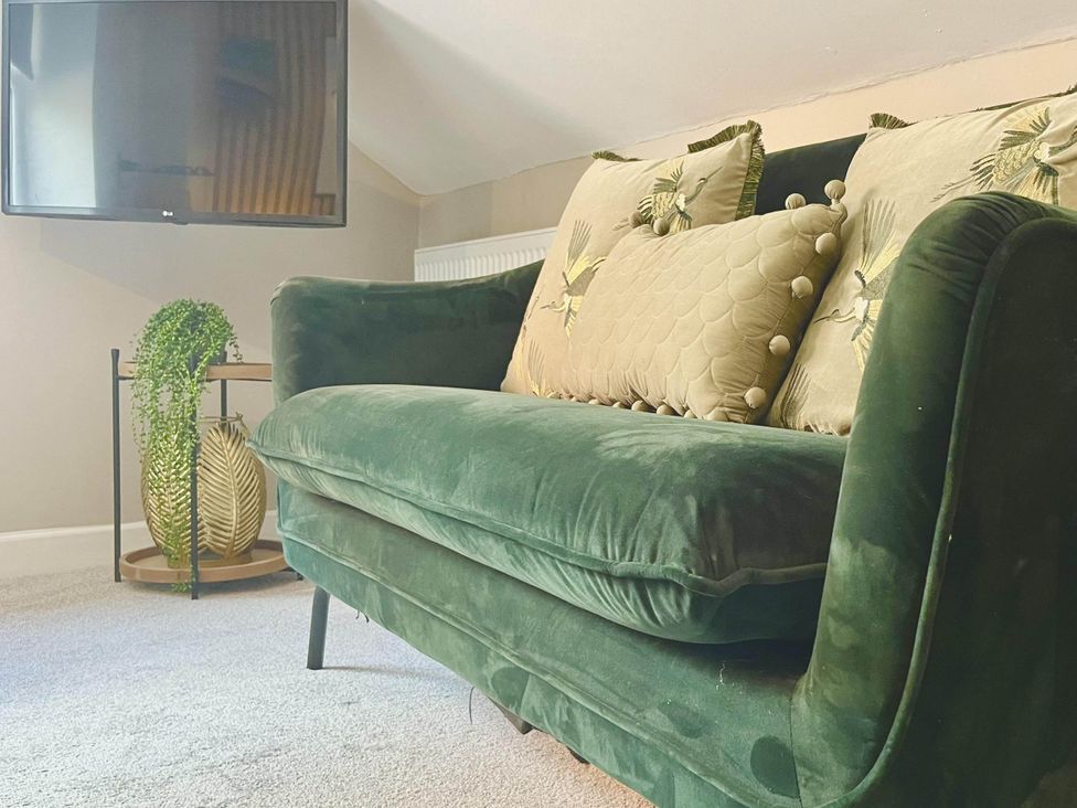 A sofa with cushions and a television at Central Ellesmere - Stay 2 - Parking - PetFriendly