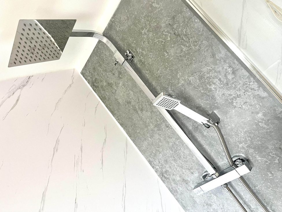 A shower system with a rain shower head and handheld shower in a bathroom at Central Ellesmere - Stay 2 - Parking - PetFriendly