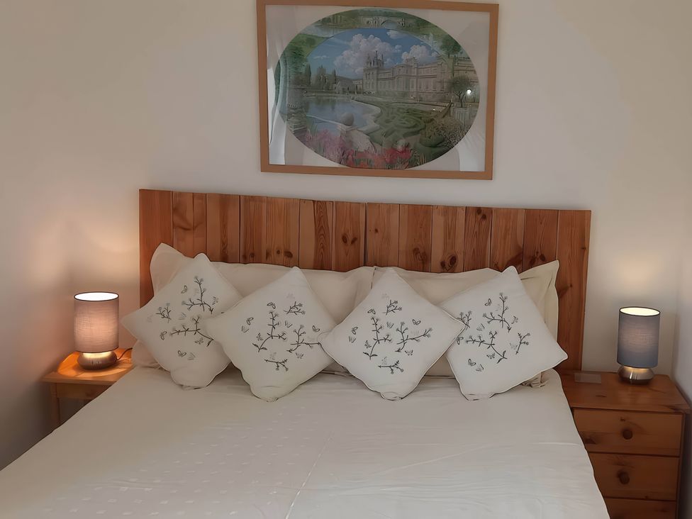 A bedroom with a bed and artwork at 2 Bed House - Sleeps 6 - Pets - Garden - Parking