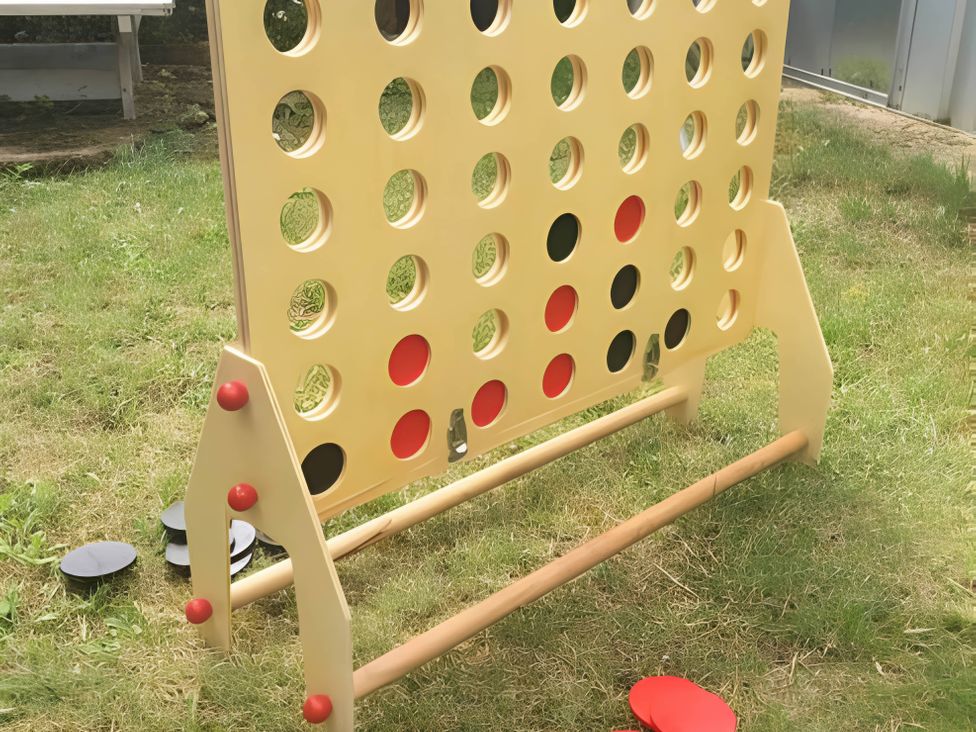 A connect four game with game pieces on grass at 2 Bed House - Sleeps 6 - Pets - Garden - Parking