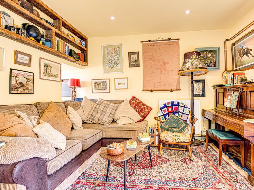 A living room with a sofa, table, and lamp at Family Country Cottage with a private Valley View