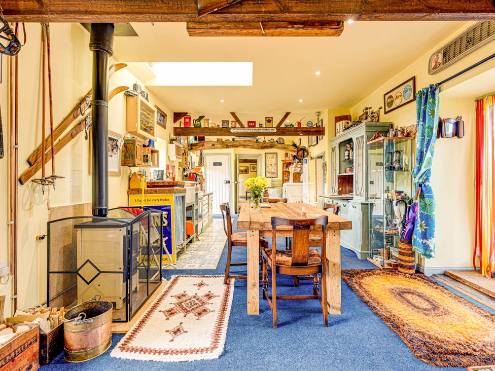 A kitchen with a wooden table and wood stove at Family Country Cottage with a private Valley View