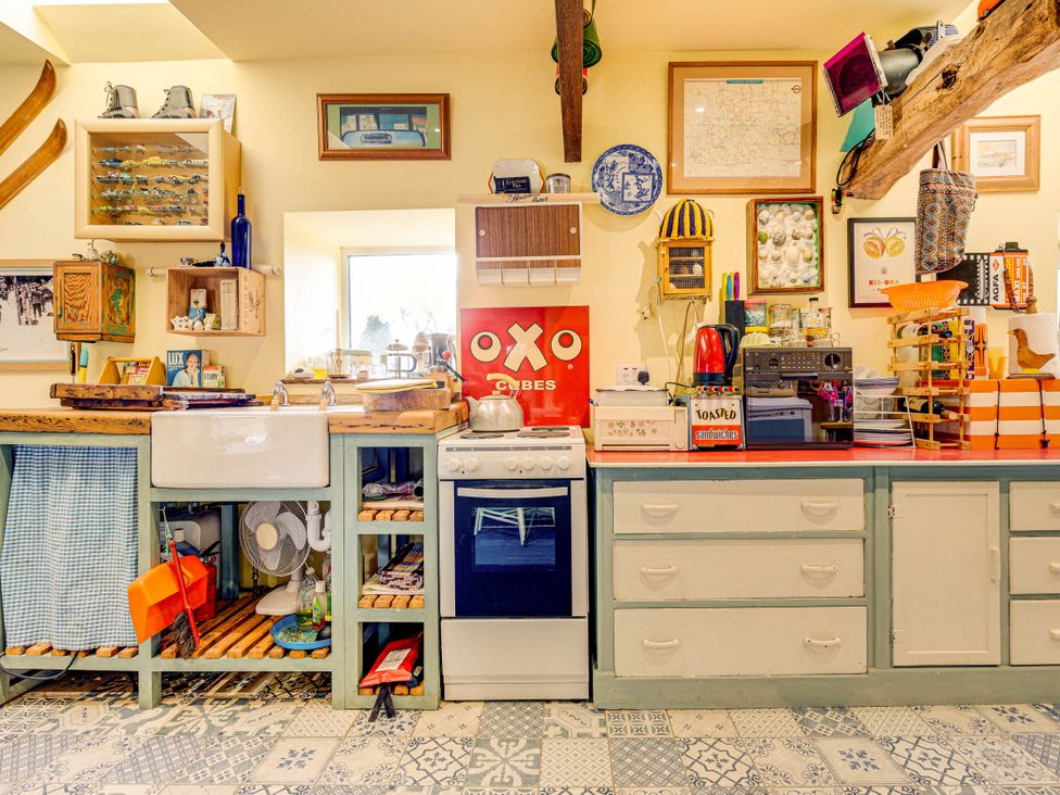 A kitchen with a sink and stove at Family Country Cottage with a private Valley View