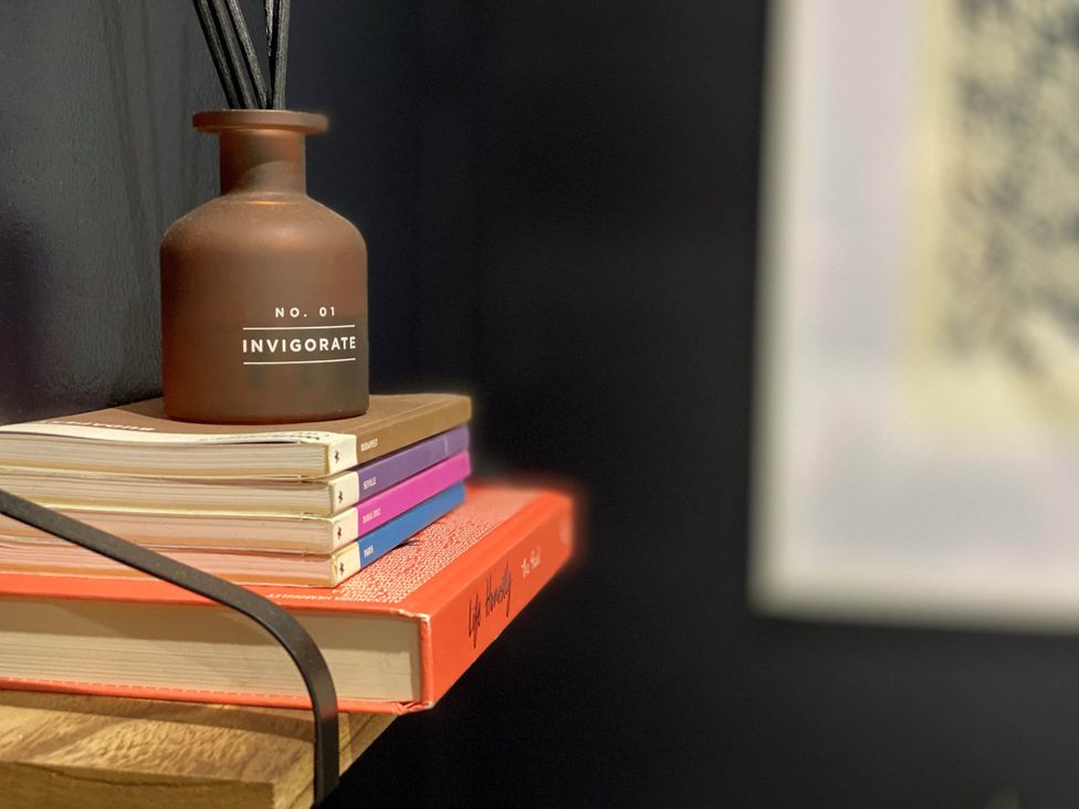 A diffuser and stacked books on a shelf at 2-Bed Flat in Summerbridge Harrogate, Pet Friendly