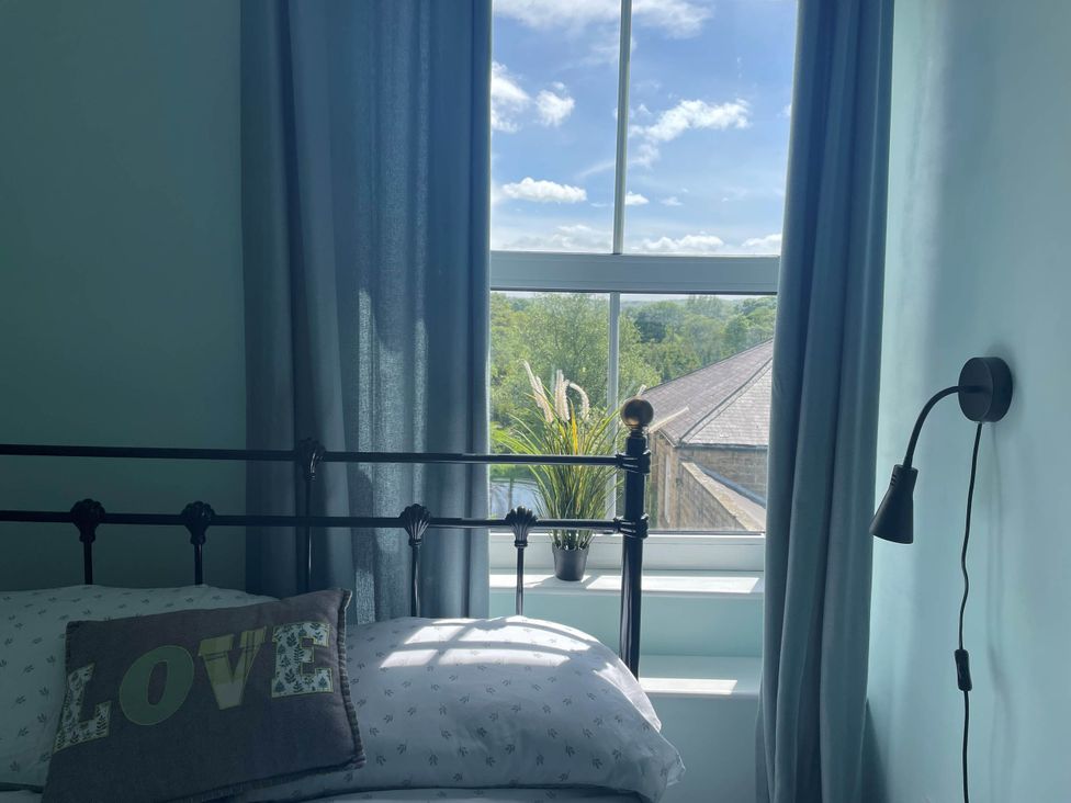 A bedroom with a bed and window at 2-Bed Flat in Summerbridge Harrogate, Pet Friendly