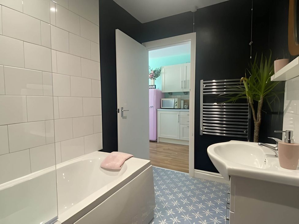 A bathroom with a bathtub and sink at 2-Bed Flat in Summerbridge Harrogate, Pet Friendly