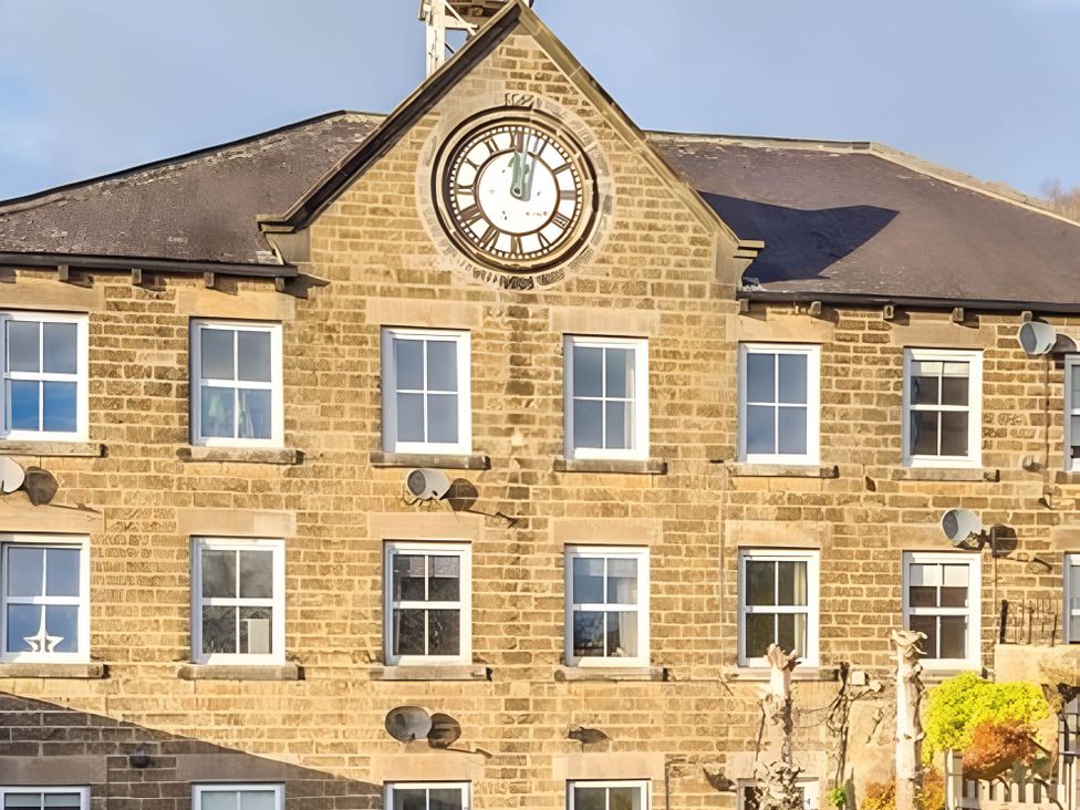 A building with a clock and windows at 2-Bed Flat in Summerbridge Harrogate