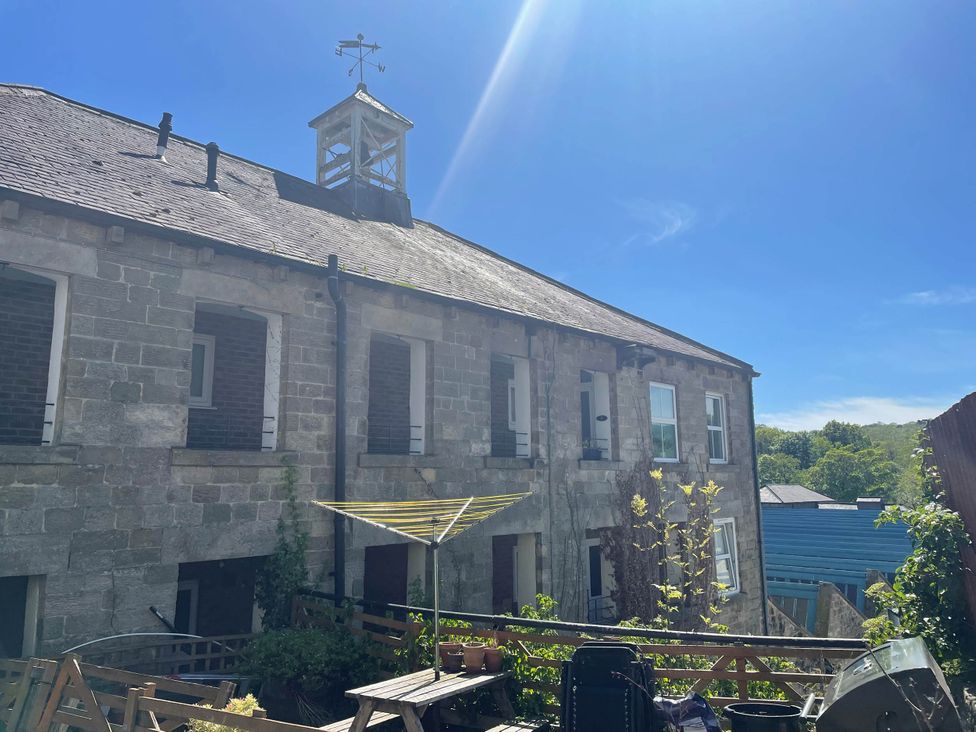 A building exterior with windows and a garden area at 2-Bed Flat in Summerbridge Harrogate, Pet Friendly