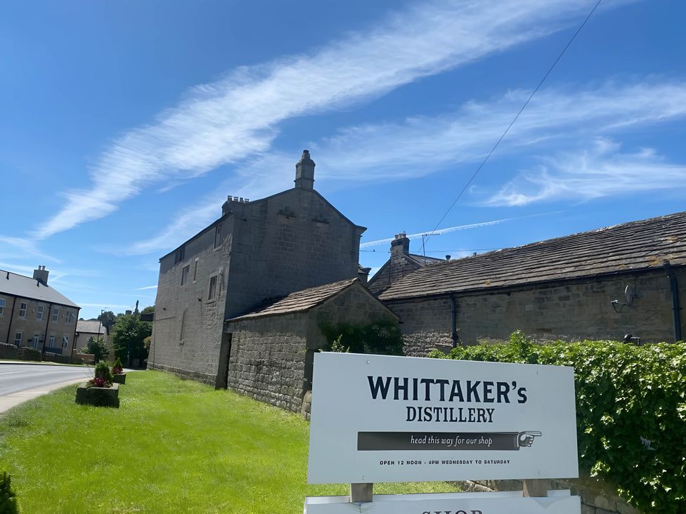 A distillery sign pointing toward the shop at Whittaker's Distillery in Summerbridge Harrogate