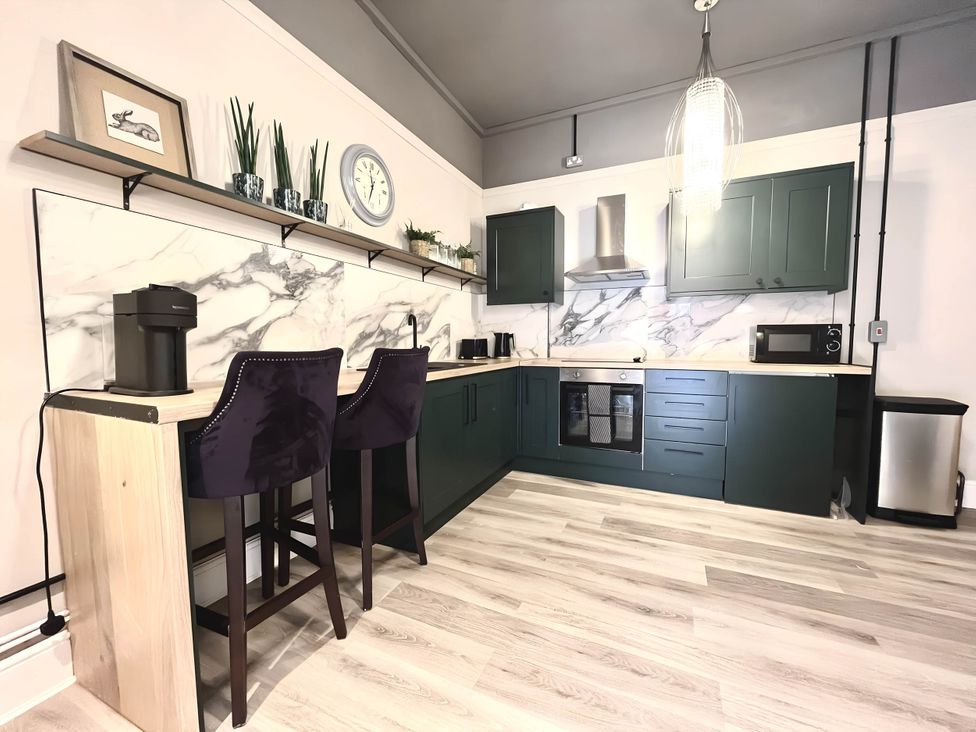 A kitchen with green cabinets and stainless steel appliances at CentralEllesmere - Sleeps4 - Parking - PetFriendly