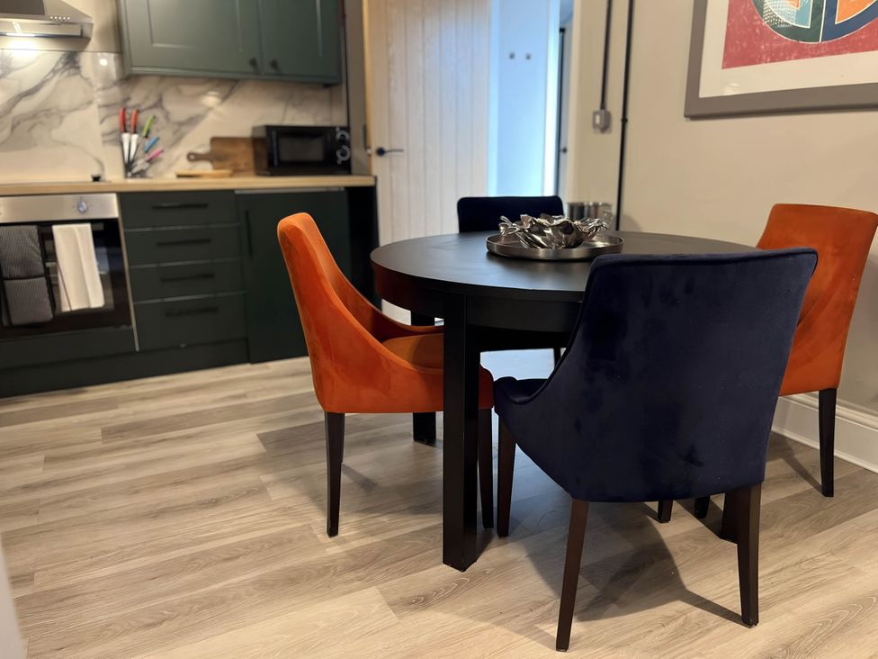 A dining room with a round table and chairs at CentralEllesmere - Sleeps4 - Parking - PetFriendly