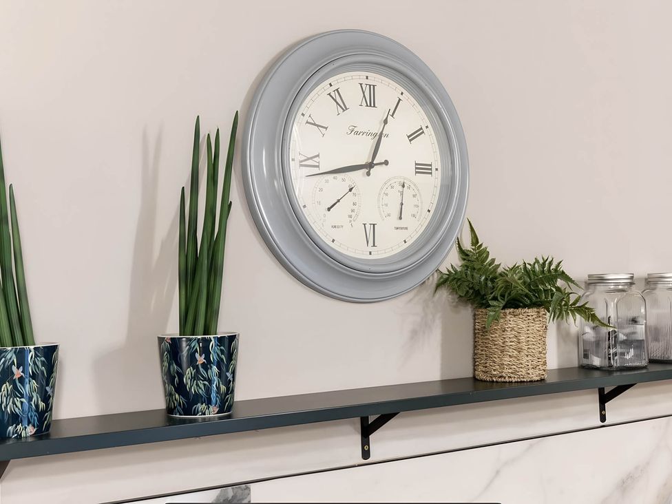 A shelf with a clock, plants, and jars at CentralEllesmere - Sleeps4 - Parking - PetFriendly