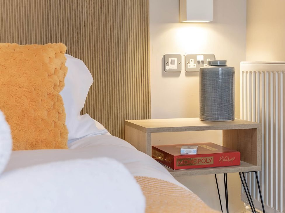 A bedroom with a bedside table and a board game at CentralEllesmere - Sleeps4 - Parking - PetFriendly 