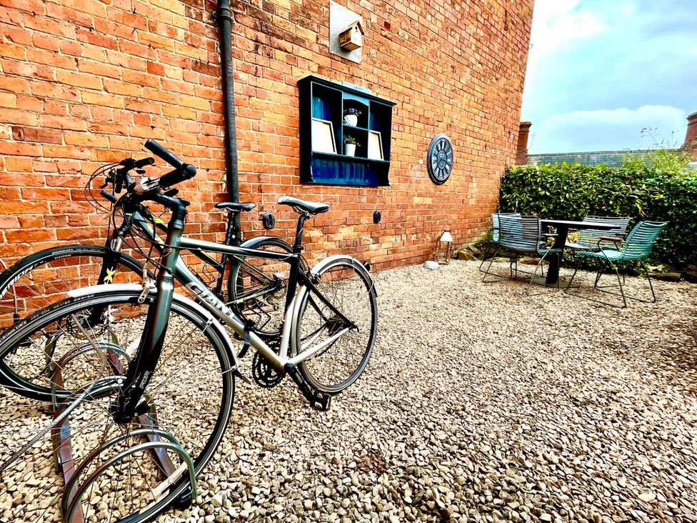 A bicycles parked beside a table and chairs in an outdoor area at CentralEllesmere - Sleeps4 - Parking - PetFriendly