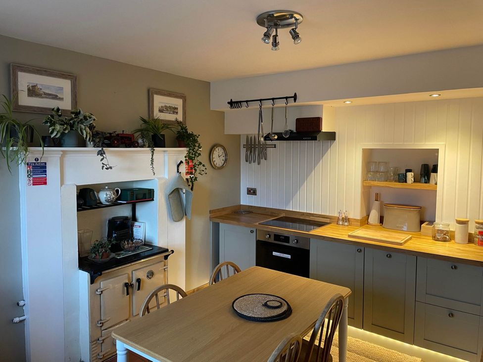 A kitchen with a table and chairs at 1 Keepers Cottage, Skeabost Bridge, Isle Of Skye