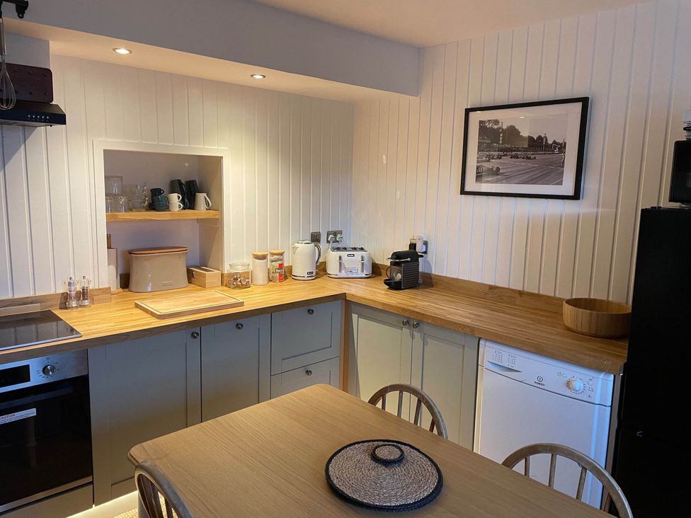 A kitchen with wooden countertop and appliances at 1 Keepers Cottage, Skeabost Bridge, Isle Of Skye