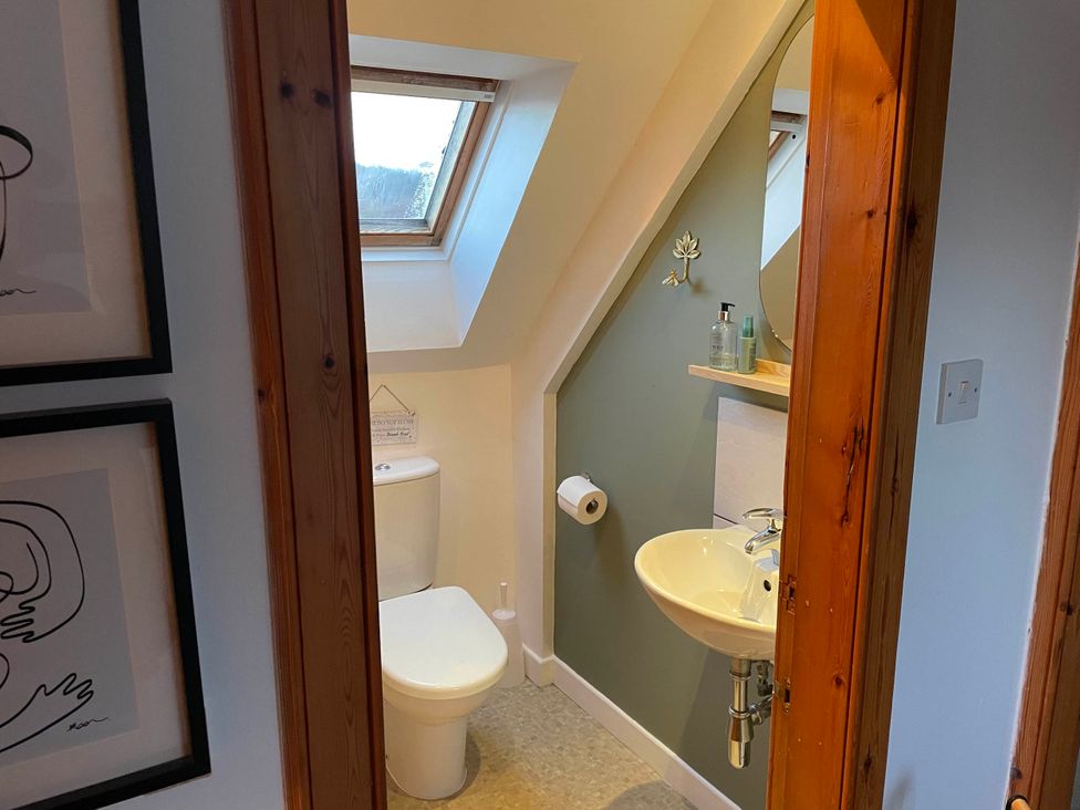 A bathroom with a toilet and sink at 1 Keepers Cottage, Skeabost Bridge, Isle Of Skye