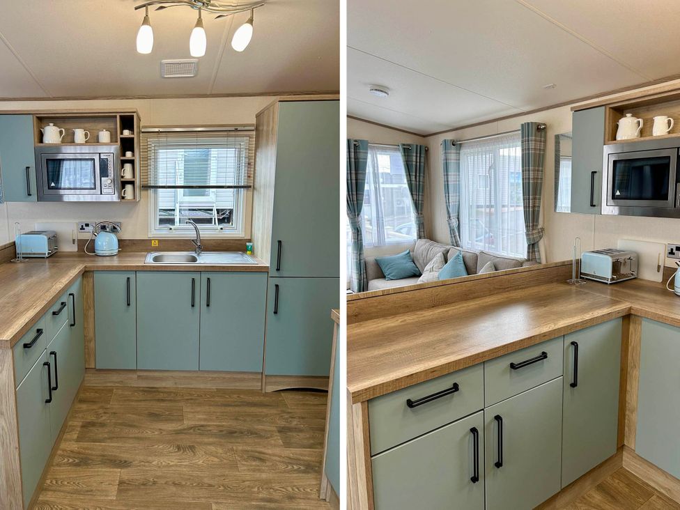 A kitchen with cabinets and appliances at Static Caravan Hoburne Devon Bay