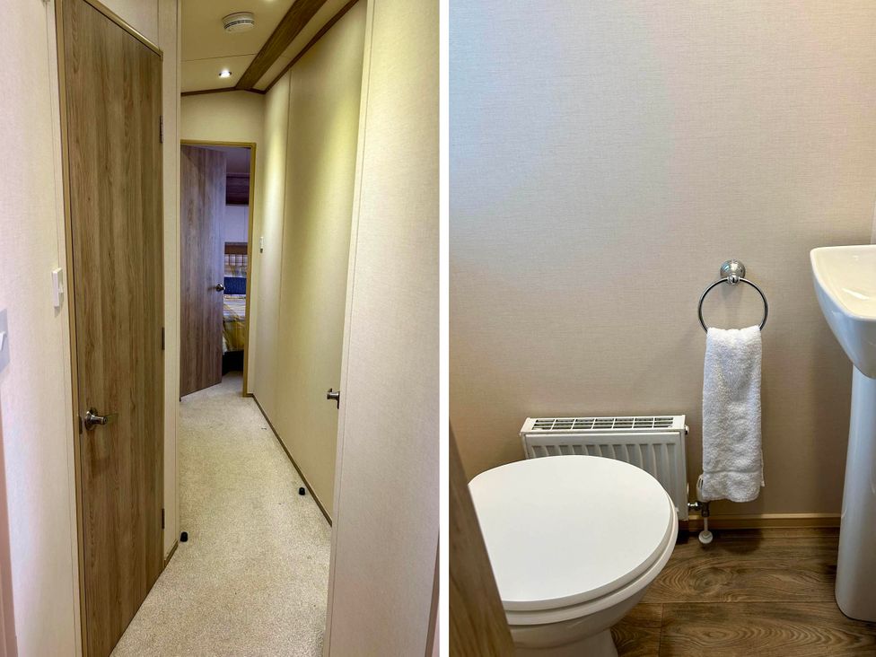 A hallway leading to a bedroom and a bathroom with sink and toilet at Static Caravan Hoburne Devon Bay