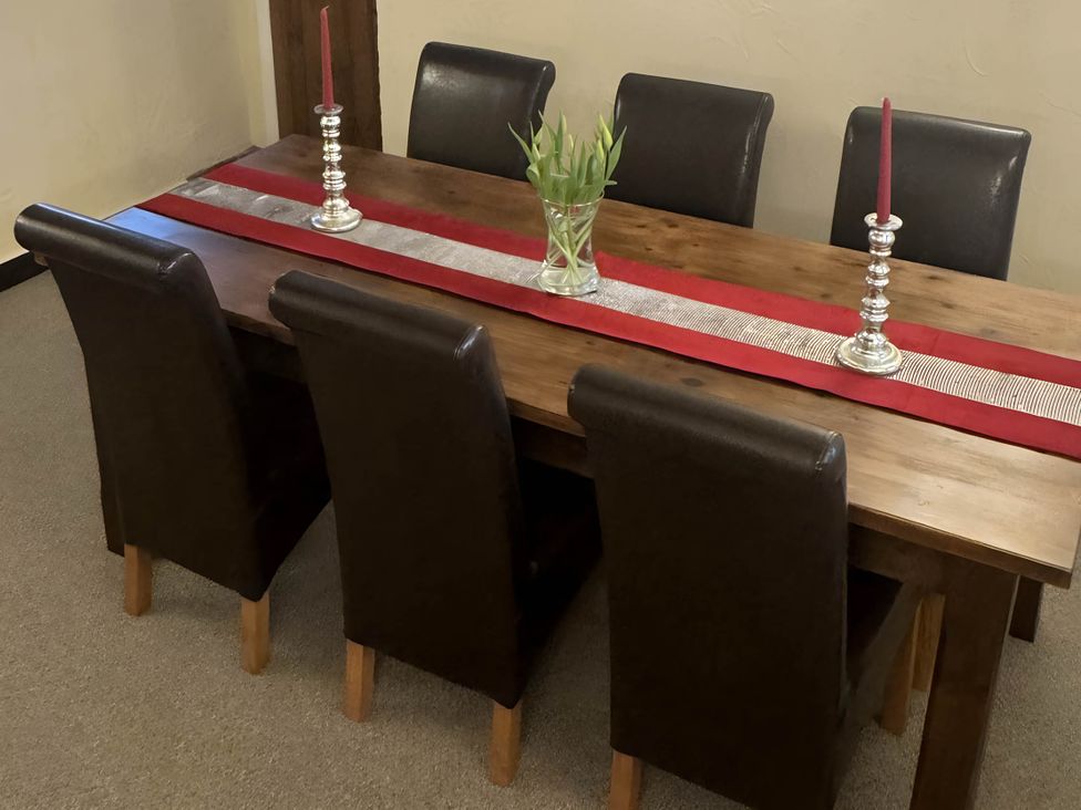 A dining table with chairs and candle holders at Stunning cottage - 3 Bedrooms & 3 Bathrooms