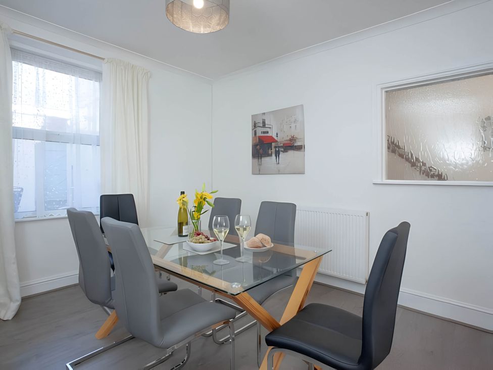 A dining room with a table set for two at Torquay - House - Sleeps 6 - Pet Friendly