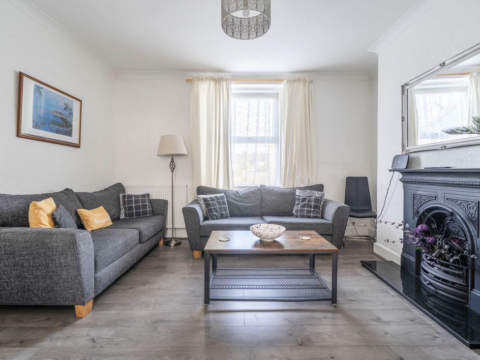 A living room with a grey sofa and a coffee table at Torquay - House - Sleeps 6 - Pet Friendly, Torquay