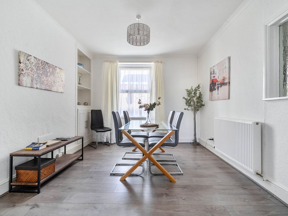 A dining room with a table and chairs at Torquay - House - Sleeps 6 - Pet Friendly, Torquay
