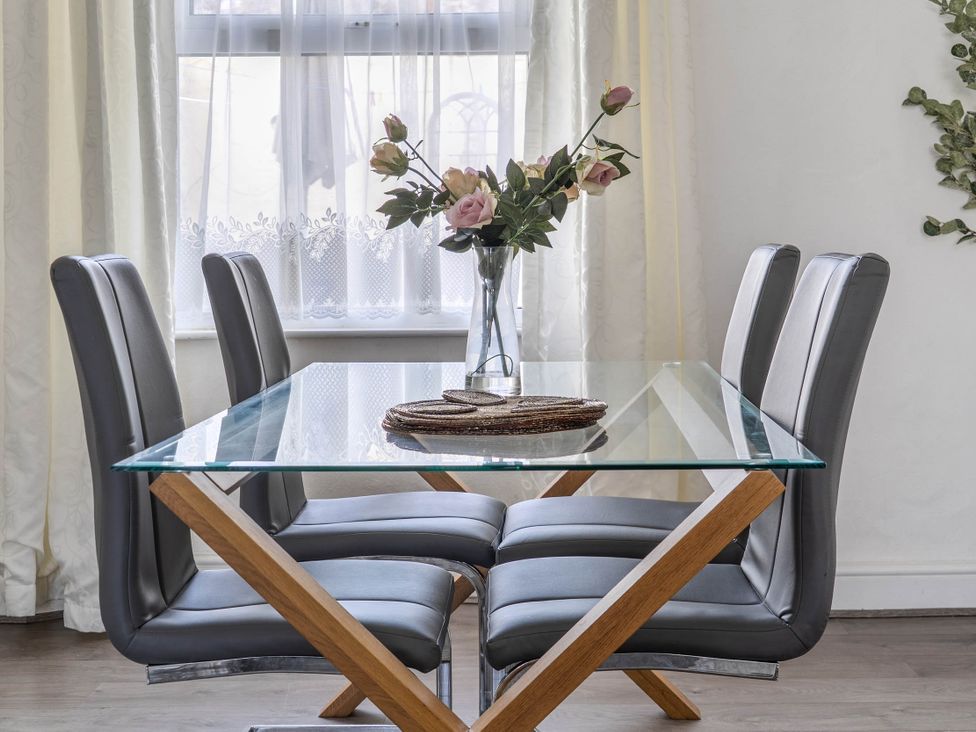 A dining room with a glass table and chairs at Torquay - House - Sleeps 6 - Pet Friendly in Torquay