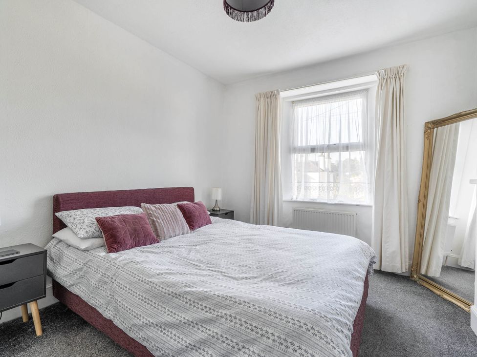 A bedroom with a bed and mirror at Torquay - House - Sleeps 6 - Pet Friendly, Torquay