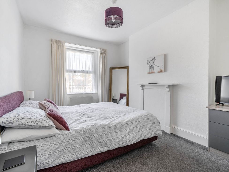 A bedroom with a bed and a television at Torquay - House - Sleeps 6 - Pet Friendly, Torquay