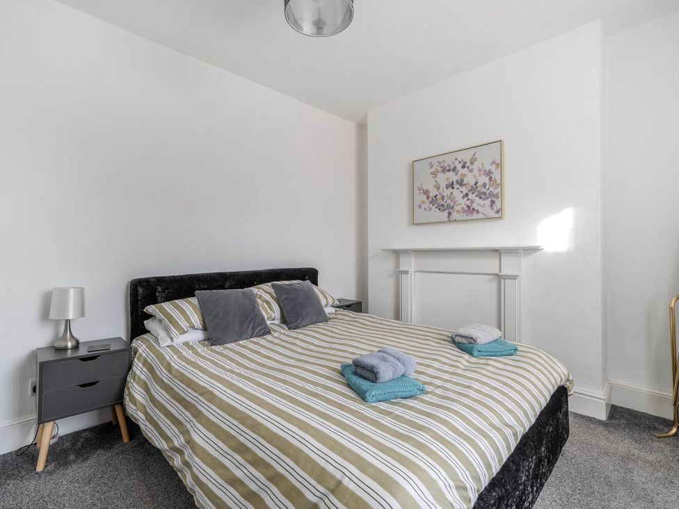 A bedroom with a bed and nightstand at Torquay - House - Sleeps 6 - Pet Friendly, Torquay