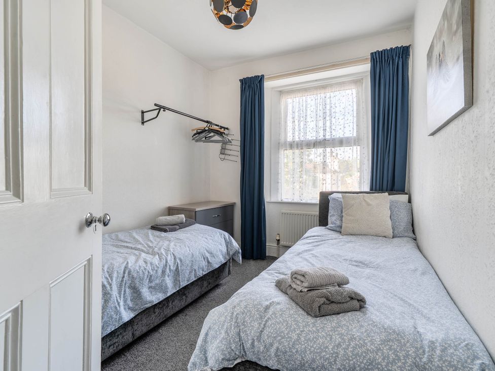 A bedroom with two beds and a nightstand at Torquay - House - Sleeps 6 - Pet Friendly, Torquay