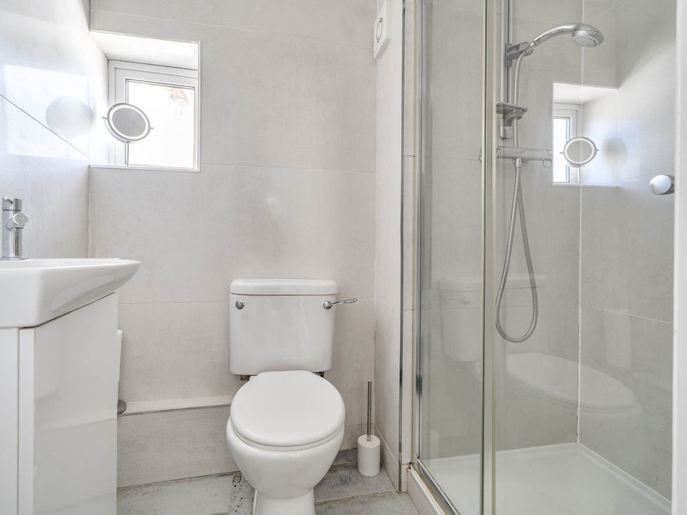 A bathroom with a sink, toilet, and shower at Torquay - House - Sleeps 6 - Pet Friendly, Torquay