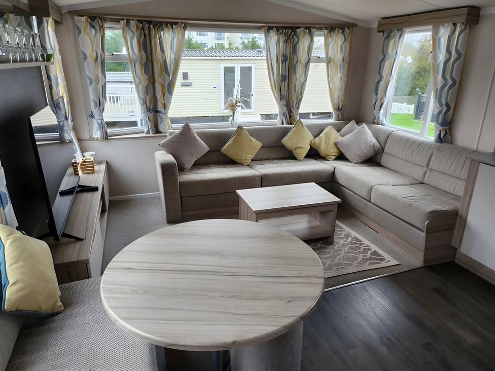 A living room with sofa and coffee table at Beverley bay 2-Bed Caravan, Sleeps 6, Pet Friendly