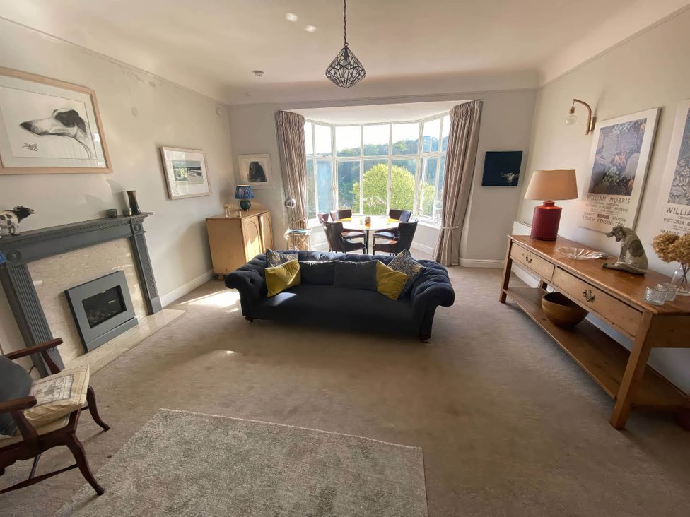 A living room with a fireplace and sofa at Beachside 2-Bed - Sleeps 4, Parking & Pet Friendly, Salcombe