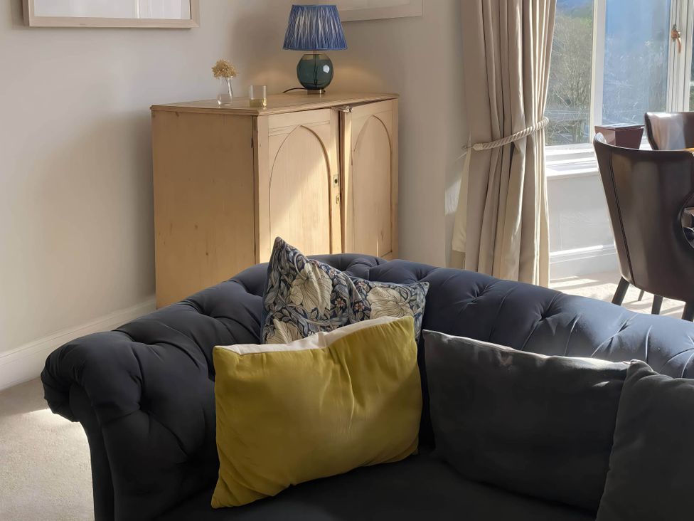 A living room with a sofa and cushions at Beachside 2-Bed - Sleeps 4, Parking & Pet Friendly, Salcombe