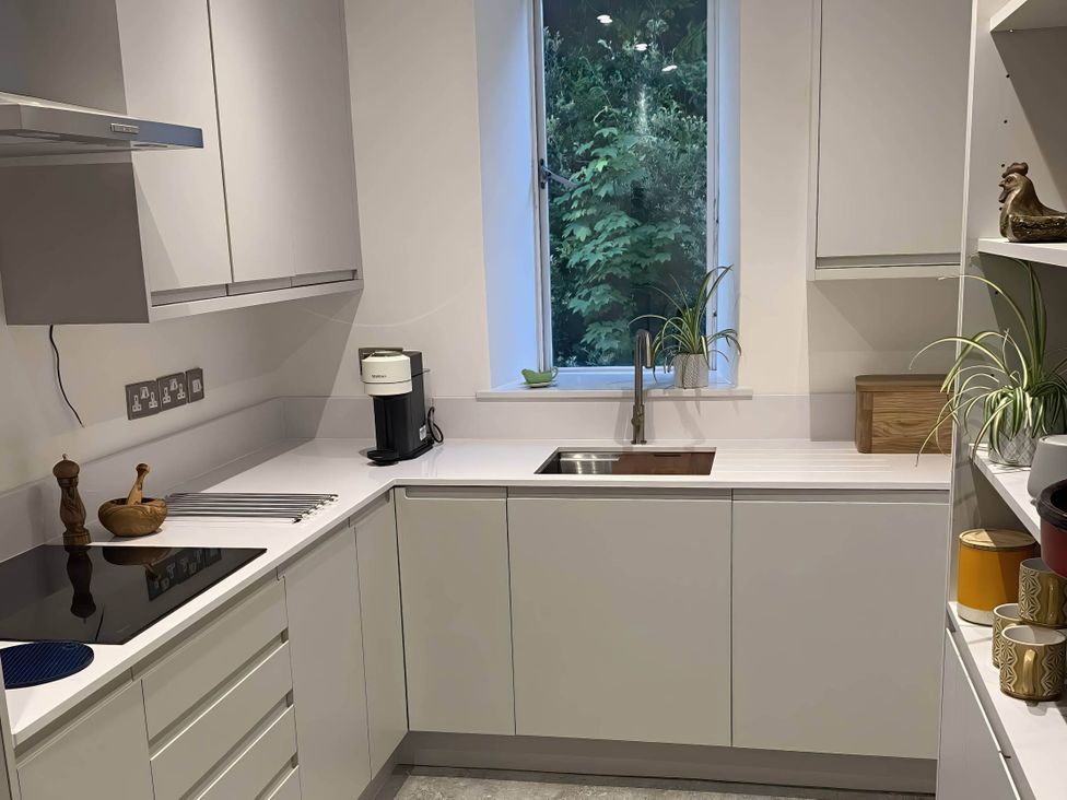 A kitchen with a sink and coffee machine at Beachside 2-Bed - Sleeps 4, Parking & Pet Friendly, Salcombe