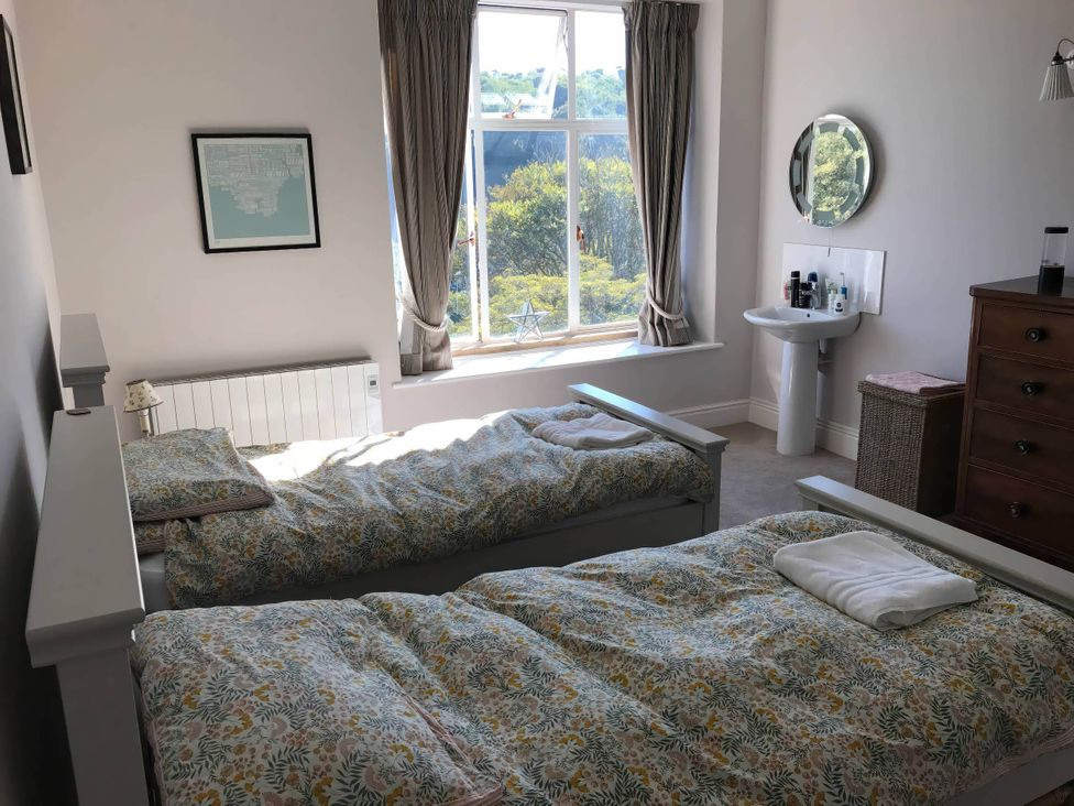 A bedroom with two beds and a window at Beachside 2-Bed - Sleeps 4, Parking & Pet Friendly, Salcombe